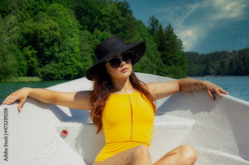 Wallpaper Mural Sexy woman on vacation. On a boat, relax enjoying a summer day Torontodigital.ca