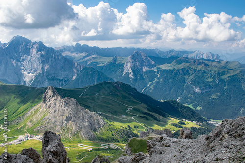 Dolomites, 2017, panoramic view from the top of the Marmolada Passo Fedaia to the green valley, mountains in the distance