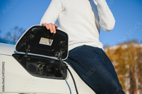 Young man charging his car