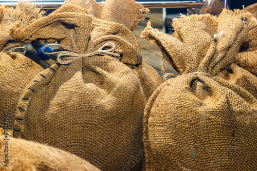 Agricultural hessian cloth sacks, rough sack material and linen fabric textile brown burlap or sackcloth bags photo