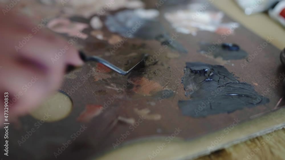 Splattering paint pallete mixing colors closeup Splattering paint pallete mixing colors closeup