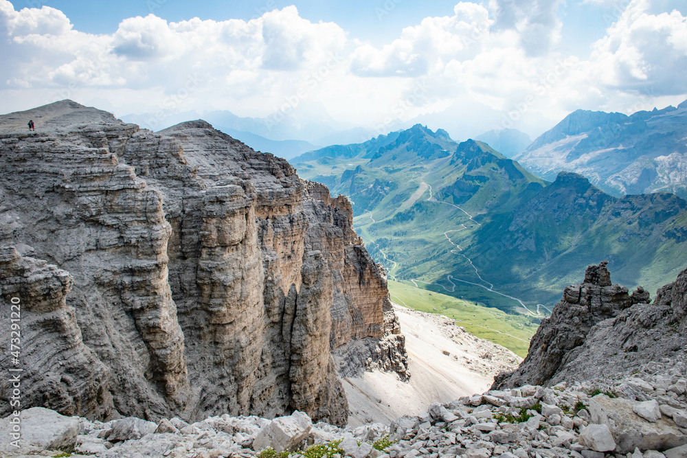 Dolomites, August, 2017, Passo Fedaia, view of the green valley from above and mountains in the distance