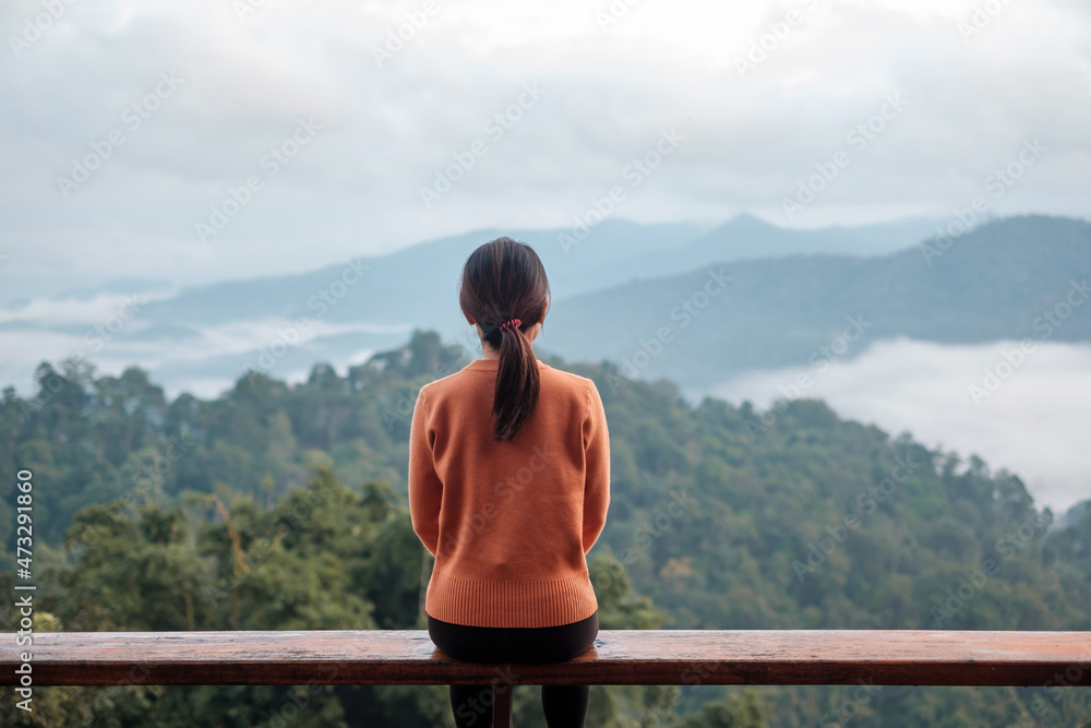 Happy woman relaxing and looking mountain view at countryside home or homestay in the morning. Vacation, blogger, SoloTravel, journey, trip and relaxing concept Happy woman relaxing and looking mountain view at countryside home or homestay in the morning. Vacation, blogger, SoloTravel, journey, trip and relaxing concept
