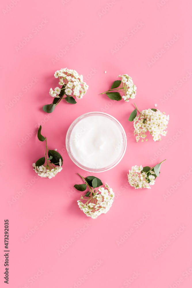 White blossoms flowers with skin cream in glass jar White blossoms flowers with skin cream in glass jar