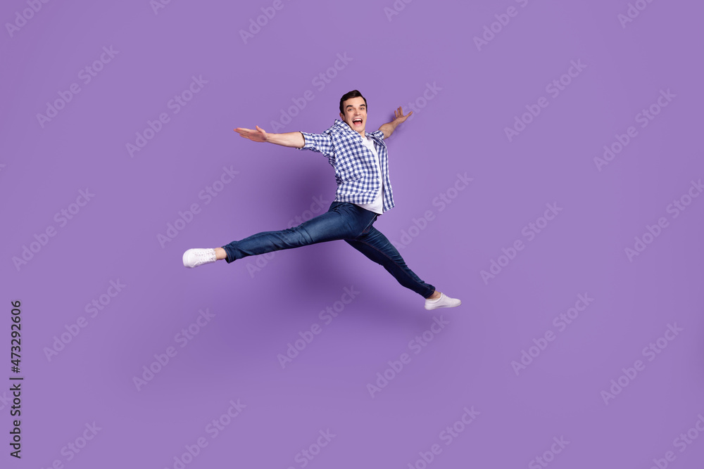 Full body profile side photo of young handsome man have fun jump up isolated over violet color background