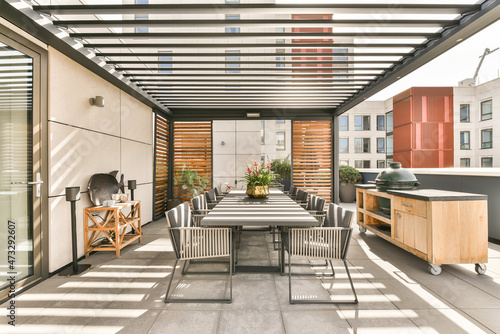 Spacious veranda with dining zone and grill photo