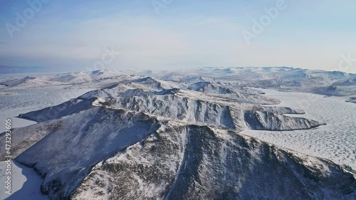 White snowy ridge in sunshine. Bird eye view winter panorama. Solitude scenery