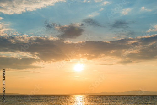 Evening sky with dramatic clouds over the sea. Dramatic sunset over the sea