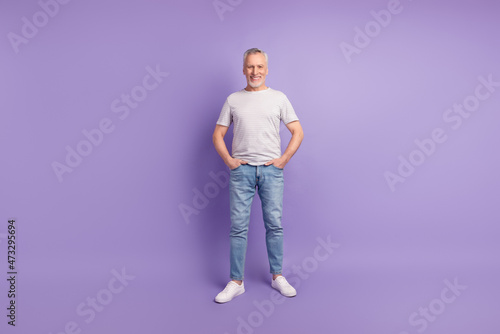 Full size photo of handsome man hands in pocket wear casual outfit isolated over violet color background