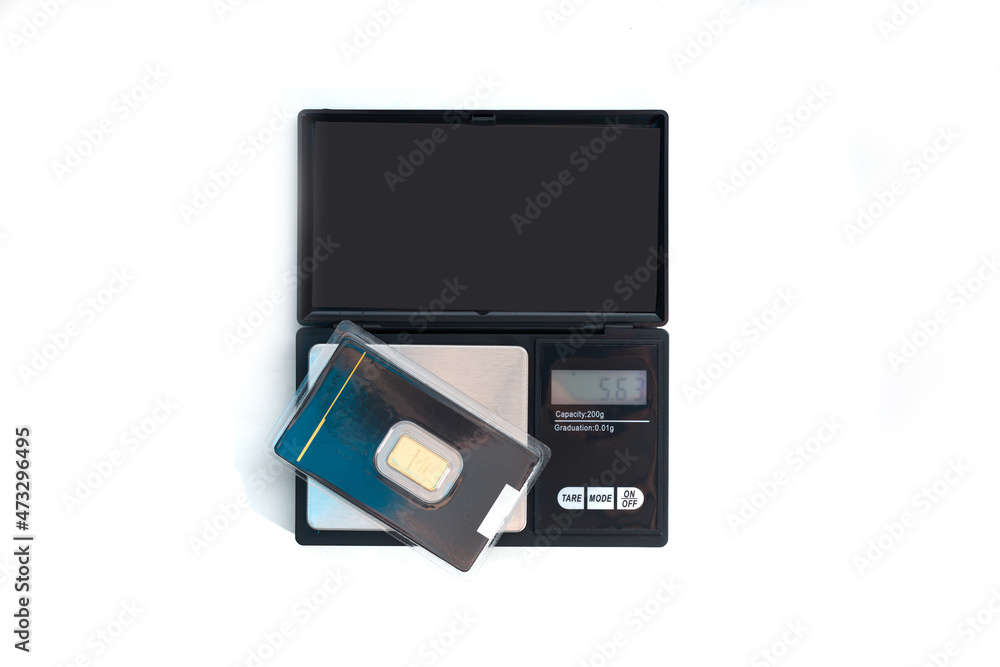 Jewelery weight with gold bars. Concept of weighing gold, gemstones. Work in jewelry, valuation of personal goods. Jewelery weight with gold bars. Concept of weighing gold, gemstones. Work in jewelry, valuation of personal goods.