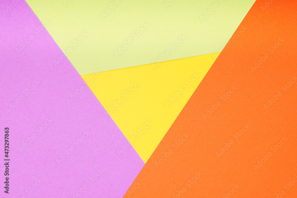 multicolor paper background with 4 different colors in triangle and rhombus shapes