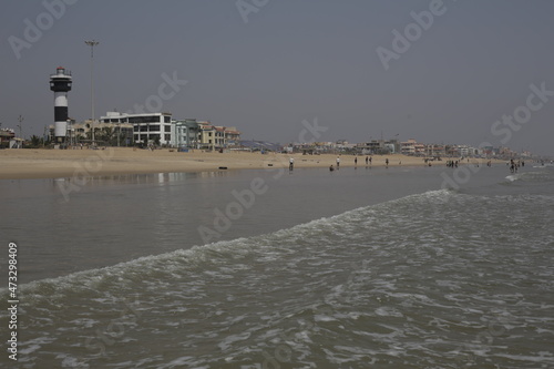 View from the water to seashore with lighthouse in India. Travel, lifestyle