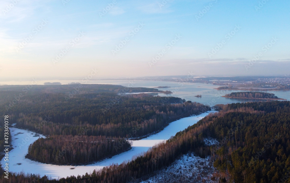 Aerial view of white snowy frozen river and forest Aerial view of white snowy frozen river and forest