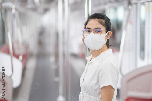 woman wearing Medical face mask prevention coronavirus inflection in train. public transportation. social distancing, new normal and safety under covid-19 pandemic
