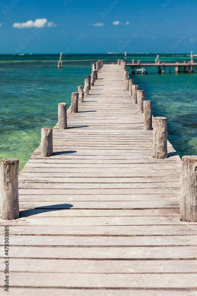A long wooden jetty or pier, stretching out over the water A long wooden jetty or pier, stretching out over the water