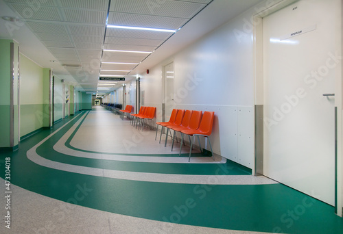 Corridor and waiting areas of a modern hospital with seating photo