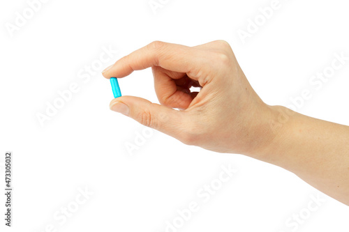 hand holding capsule or pill isolated on white