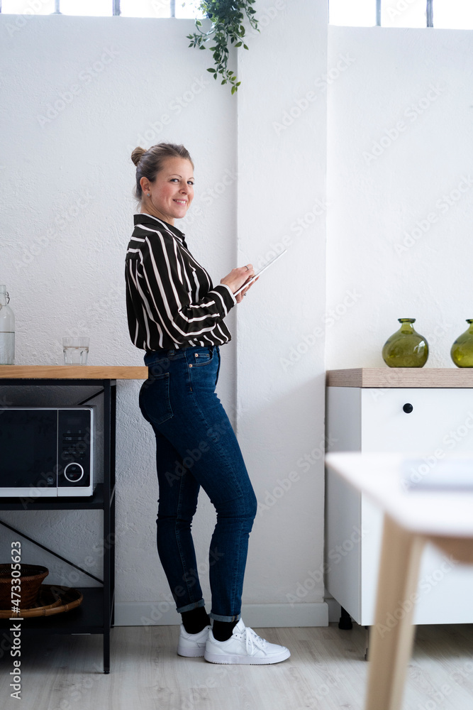 Smiling businesswoman with tablet PC at home Smiling businesswoman with tablet PC at home