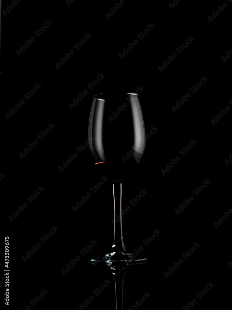 wine and champagne glass on black background with pouring red wine
wine and champagne glass on black background with pouring red wine
