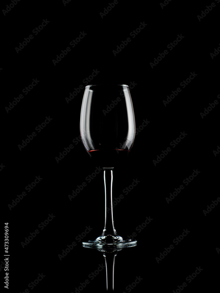 wine and champagne glass on black background with pouring red wine
wine and champagne glass on black background with pouring red wine