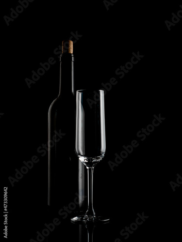  wine and champagne glass on black background with pouring red wine
