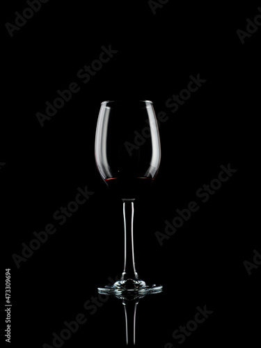  wine and champagne glass on black background with pouring red wine