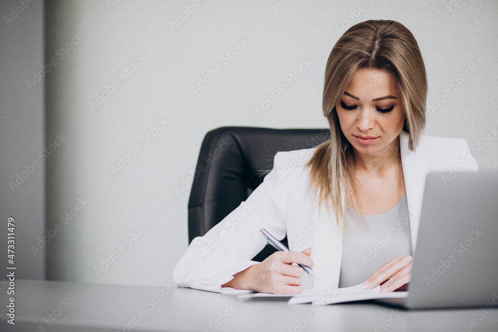 Attractive business woman working on computer in office Attractive business woman working on computer in office