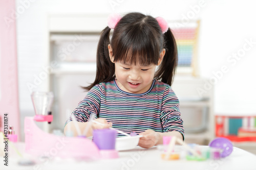 young girl making slime ar home