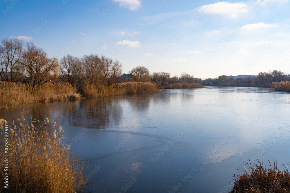 blue sky reflected in the lake and yellow leaves create a golden edging