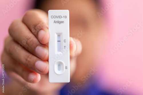 Rapid Covid-19 coronavirus strip test cassette for antibody or sars-cov-2 virus disease in hands epidemic concept background close-up