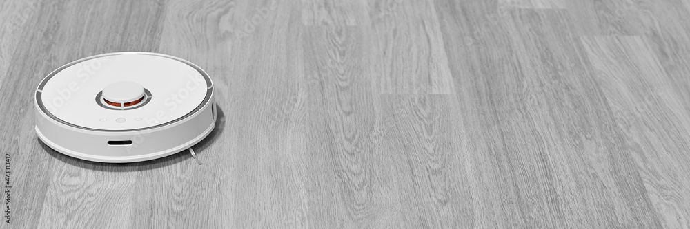Banner with a white robot vacuum cleaner. The robot vacuum cleaner cleans the room. Black and white banner. Banner with a white robot vacuum cleaner. The robot vacuum cleaner cleans the room. Black and white banner.