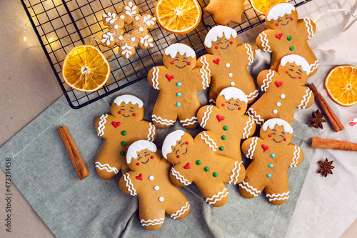 Flat lay composition with delicious homemade Gingerbread Christmas cookies on baking rack and textile napkin. Greeting card. New Year and Christmas.