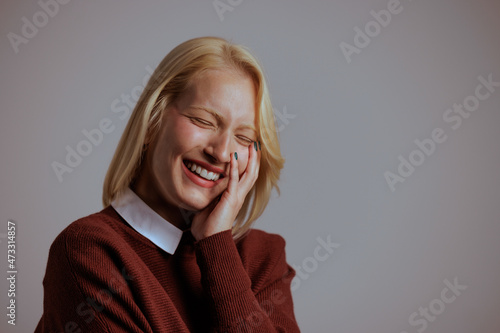 Laughing caucasian woman, feeling relaxed, while honestly smiling. photo