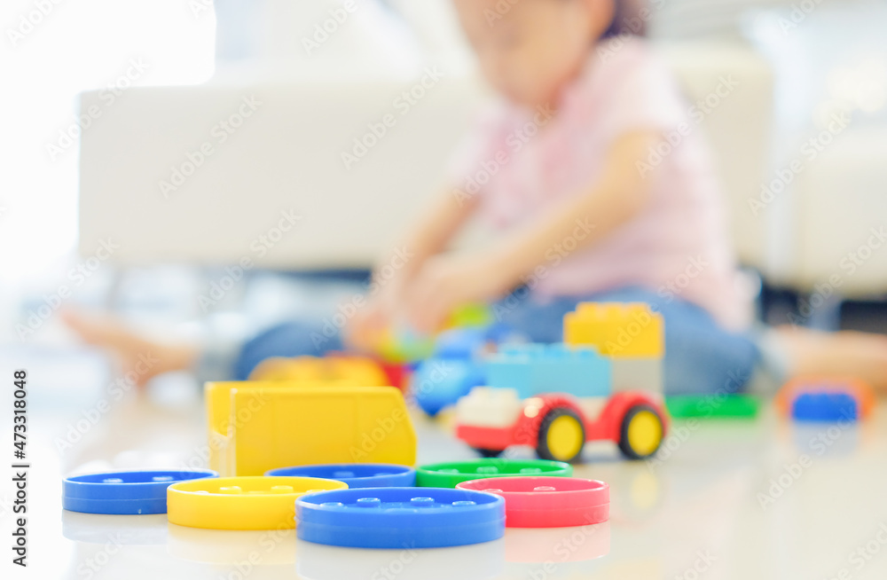 Little cute asia girl playing plastic colorful toys Little cute asia girl playing plastic colorful toys