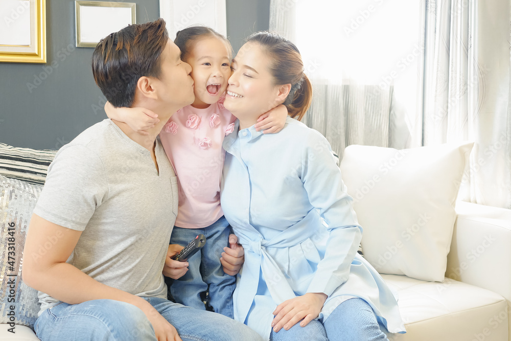 happy Asia family on sofa in living room