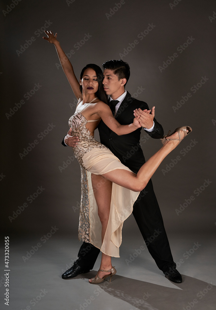 Studio shoot Latin woman and asian man dancing tango ballroom Studio shoot Latin woman and asian man dancing tango ballroom