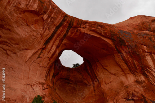 Close up of Bowtie Arch on the Corona Arch hiking trail after thunderstorm. Moab, Utah, USA.