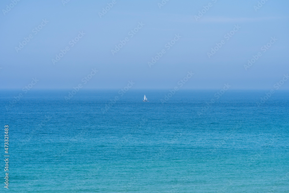 Minimalist yacht in the sea on a clear day