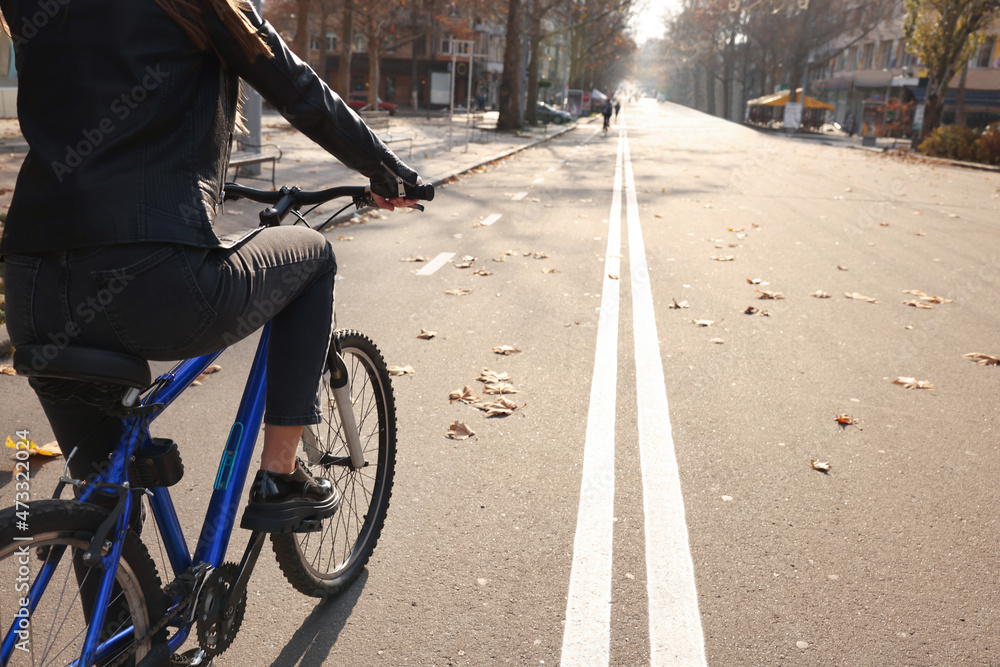 Woman with bicycle on lane in city, closeup