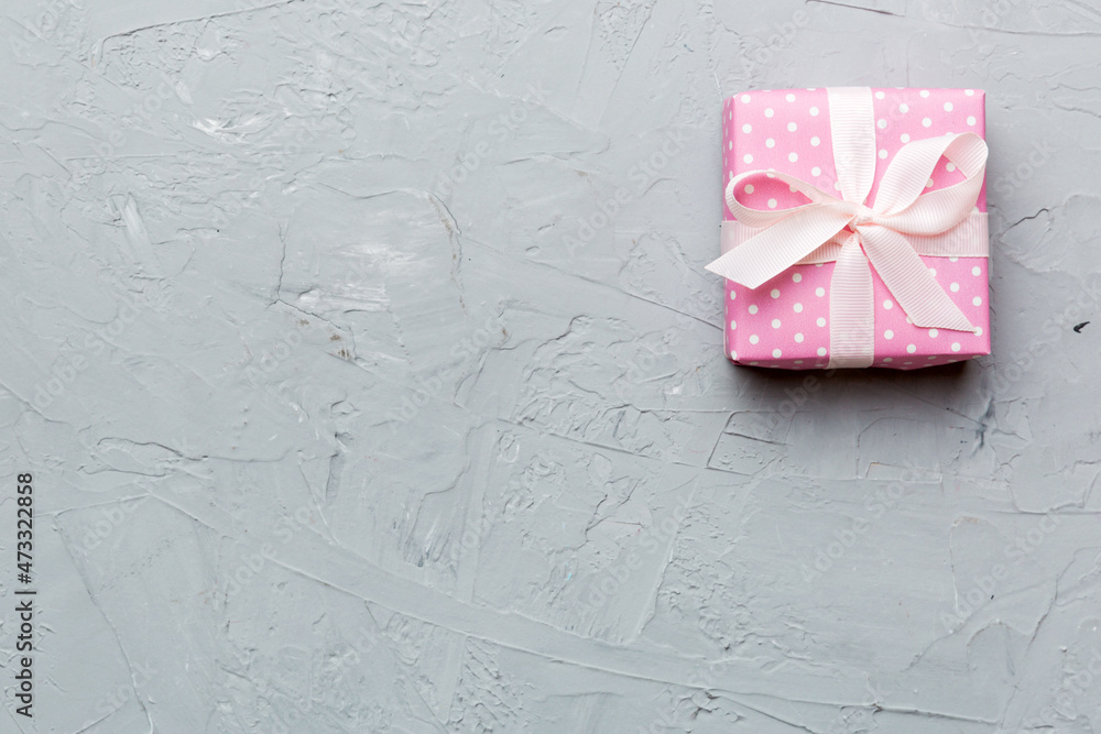 Valentine day composition: red gift box with bow and heart. Christmas present. View from above. Space for text. Holday greeting card Valentine day composition: red gift box with bow and heart. Christmas present. View from above. Space for text. Holday greeting card