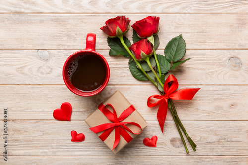 Valentine day composition with coffee cup, rose flower and gift box on table. Top view, flat lay. Holiday concept