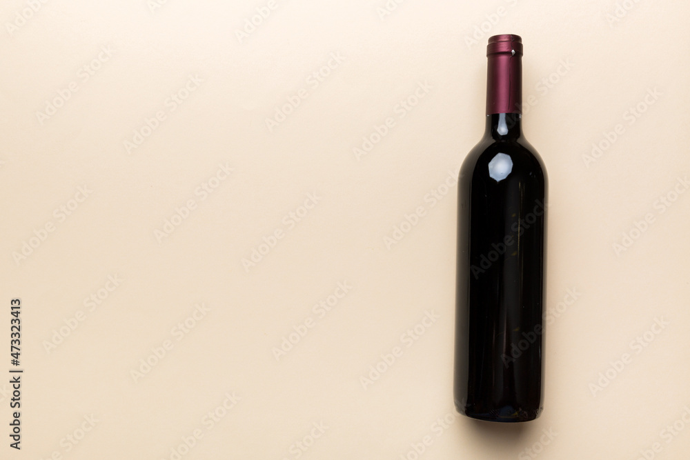 One Bottle of red wine on colored table. Flat lay, top view wth copy space One Bottle of red wine on colored table. Flat lay, top view wth copy space