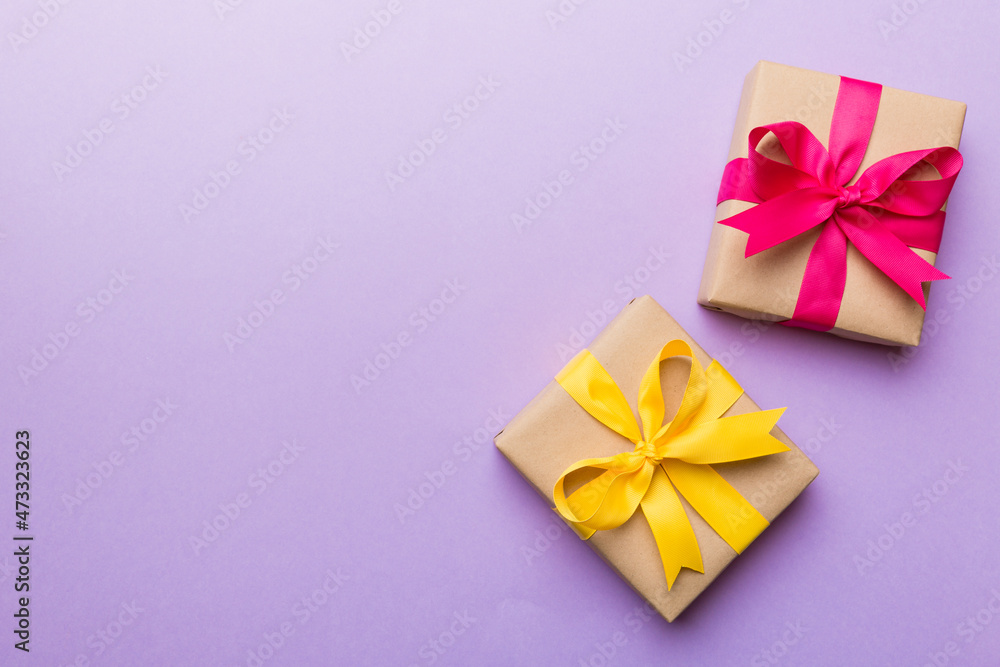 Holiday present box over colored background, top view Holiday present box over colored background, top view