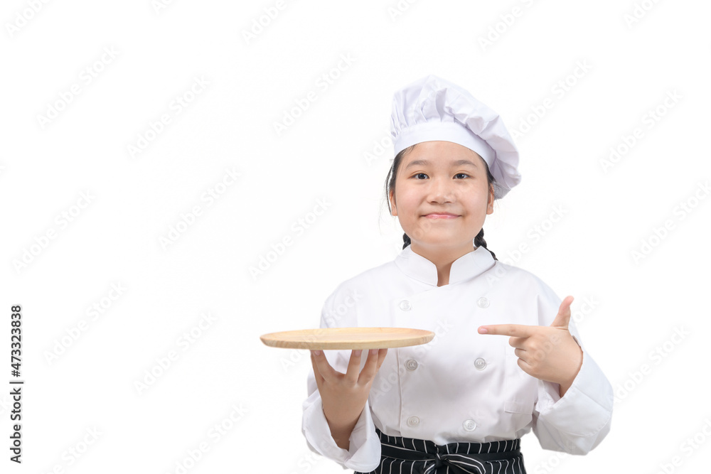 cute girl chef holds wooden plate and points her finger at plate. food menu presentation cute girl chef holds wooden plate and points her finger at plate. food menu presentation