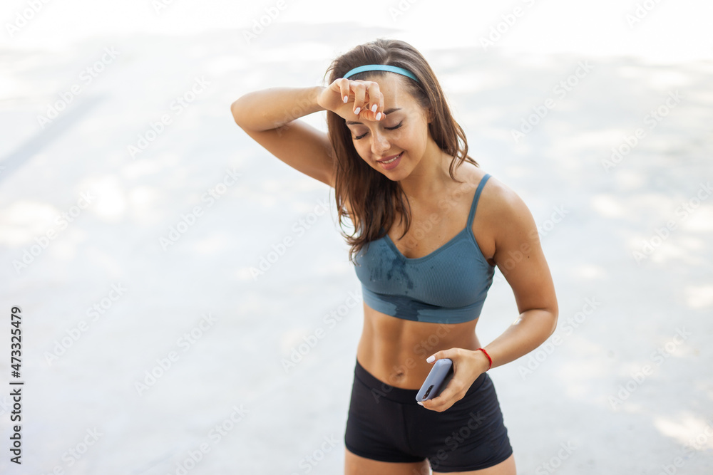 Sweaty tired athletic woman in sportswear outdoors Sweaty tired athletic woman in sportswear outdoors