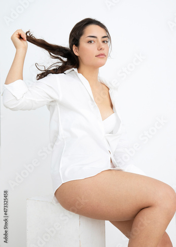 Seductive woman playing with hair against white background