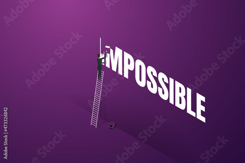 Businesswoman erases impossible words using paint roller.
