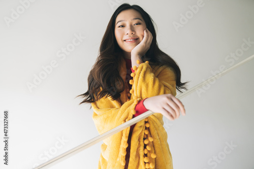 Young woman leaning on glass railing at home