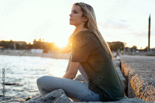 Blond woman contemplating at Bogatell beach, Barcelona, Catalonia, Spain photo