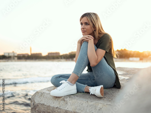 Woman contemplating at Bogatell beach, Barcelona, Catalonia, Spain photo